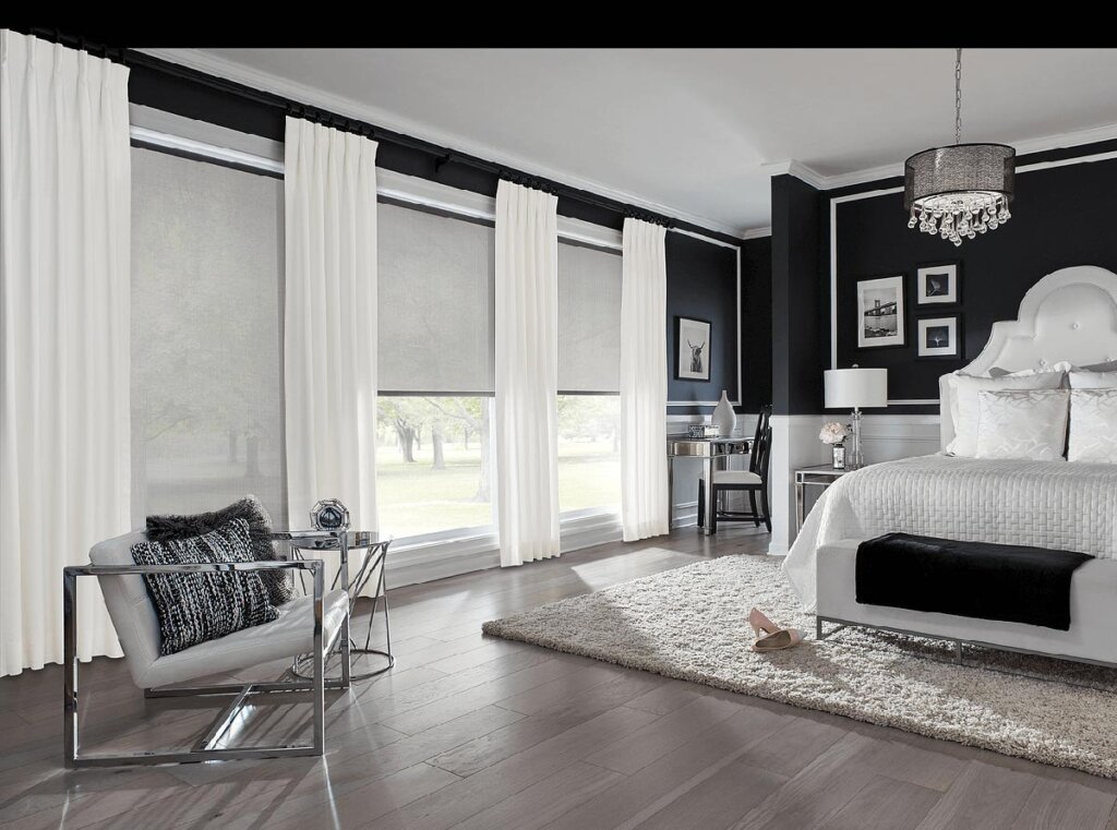 White-curtains-along-with-cellular-shades-complete-this-elegant-black-and-white-bedroom-look
